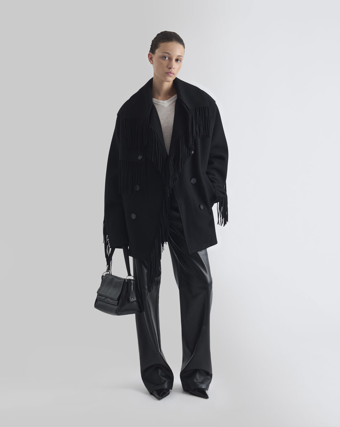 Sort oversized IRO Paris Drifter uldjakke med frynser langs krave, front og ærmer, bred reverskrave og dobbeltradet knaplukning forfra i fuld figur