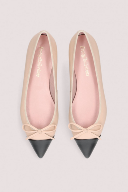 Elegante beige ballerinasko med sort spids tå, dekorativ sløjfe og flad sort sål.