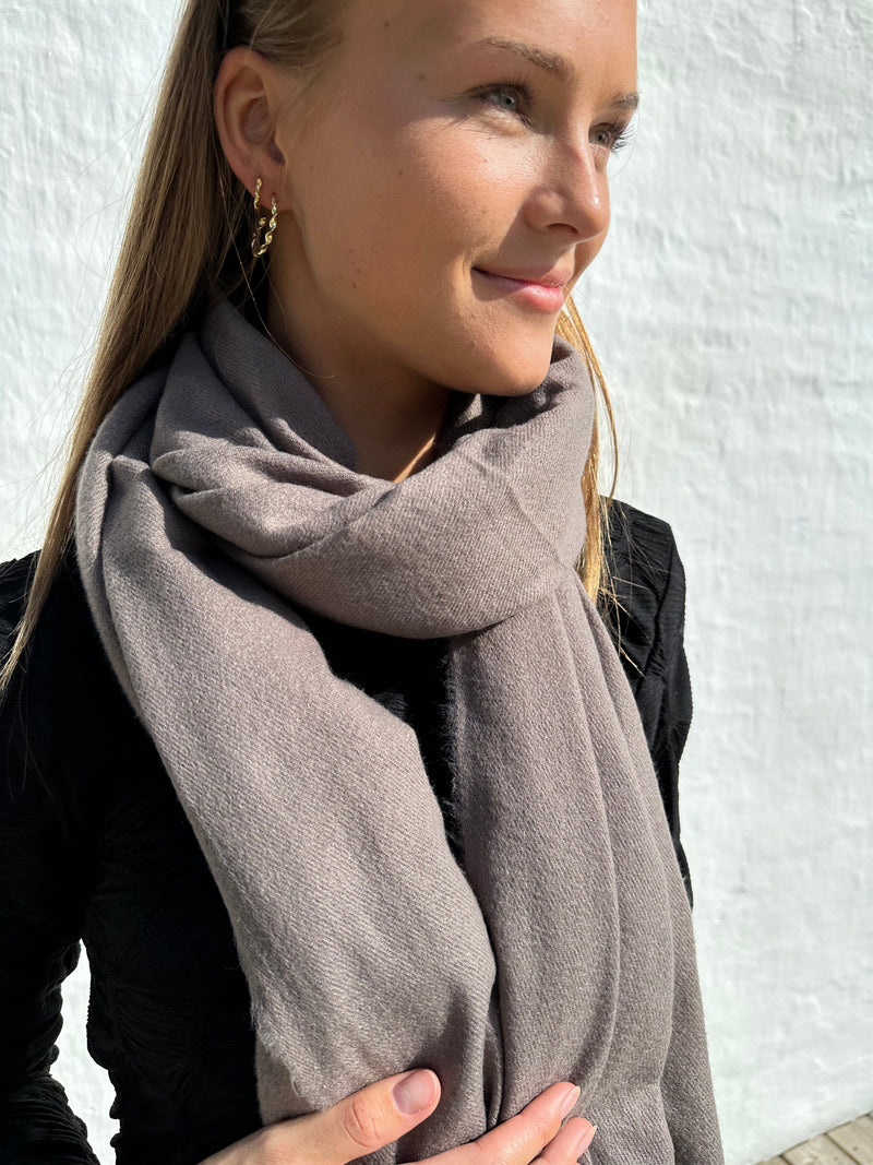 Kvinde iført Andcopenhagen Basics 70% cashmere tørklæde i farven Dark coffee, model Yana.