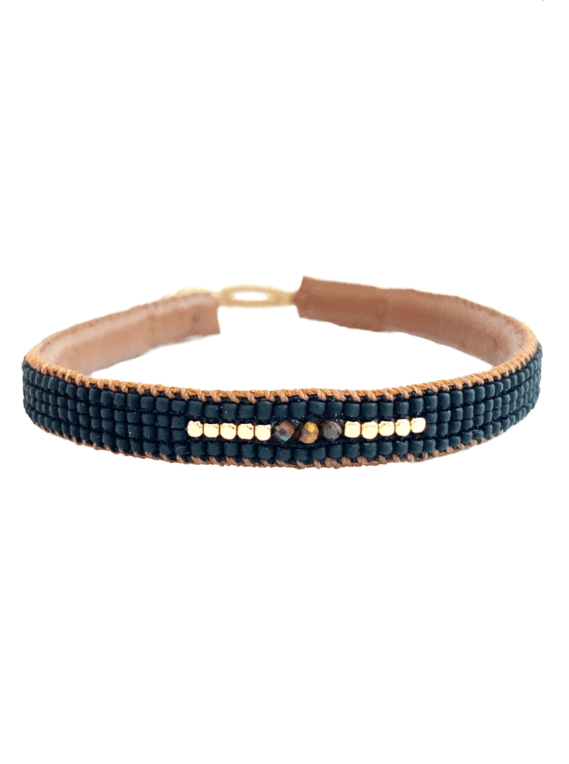 Håndlavet armbånd med mørke perler og metalliske detaljer, enkel lukning, symmetrisk mønster.