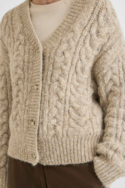 Vila ROUELLIS L/S Knit Cardigan in Pelican color, featuring a cable knit pattern, V-neck, and button closure, worn by a model