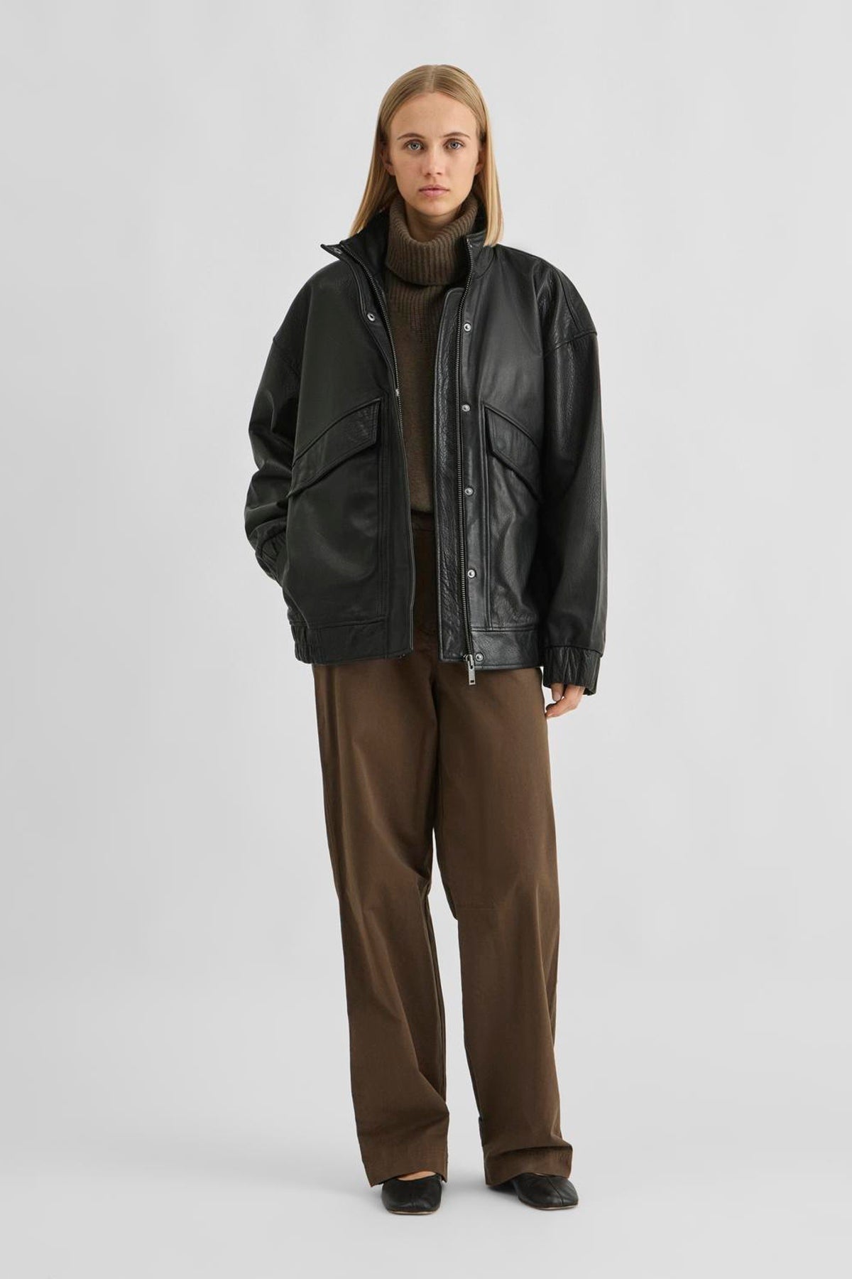 Vila ROUSIMONE oversized leather jacket in meteorite black, made from buffalo leather, shown on a model with long sleeves.
