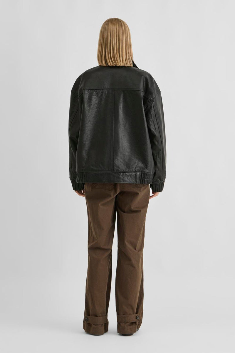 Vila ROUSIMONE oversized leather jacket in meteorite color, shown from the back on a model, featuring long sleeves and a bike